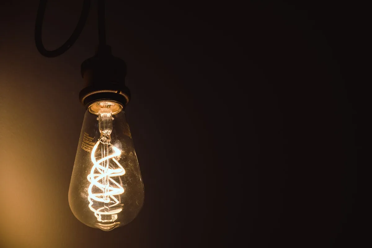 A 100-watt Edison filament incandescent light bulb