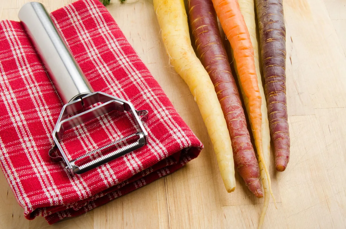 A close-up image of a sharp vegetable peeler blade.